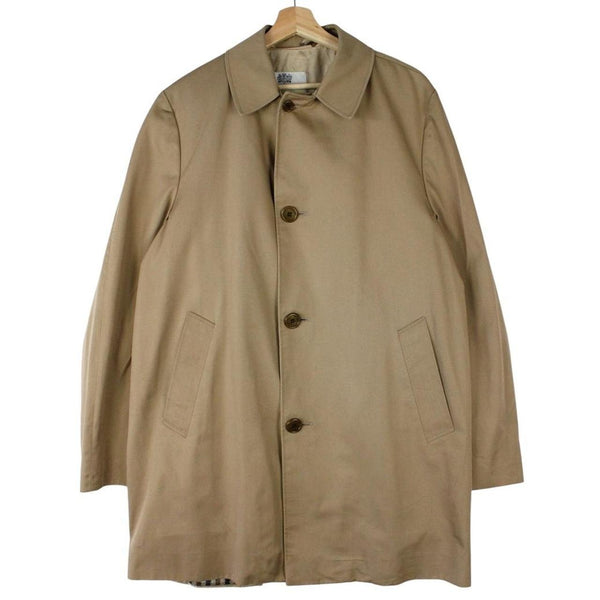 Aquascutum tan brown trench coat with house check pattern and removable wool lining.