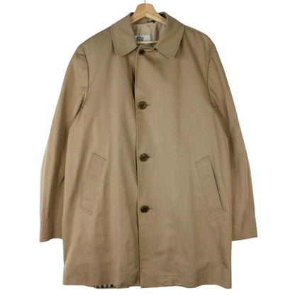 Aquascutum tan brown trench coat with house check pattern and removable wool lining.