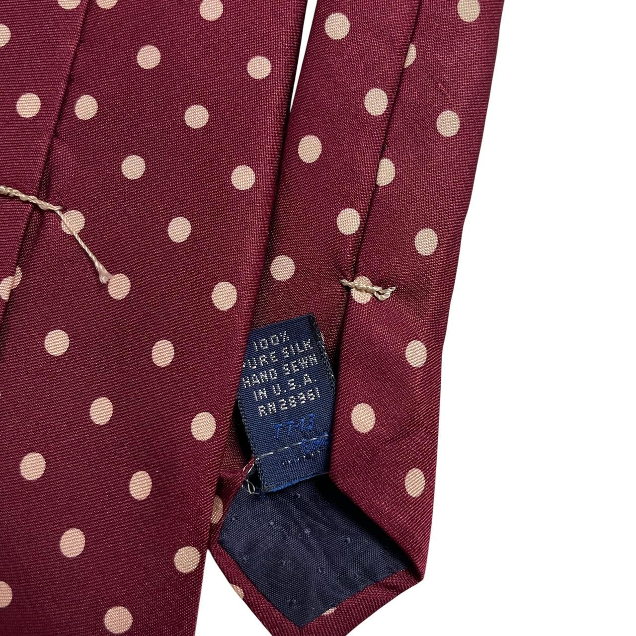Burberry burgundy silk tie with white polka dots and classic logo detail.