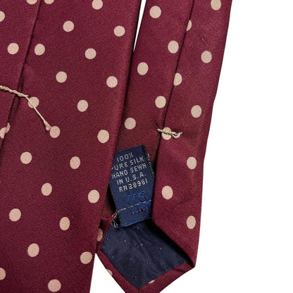 Burberry burgundy silk tie with white polka dots and classic logo detail.