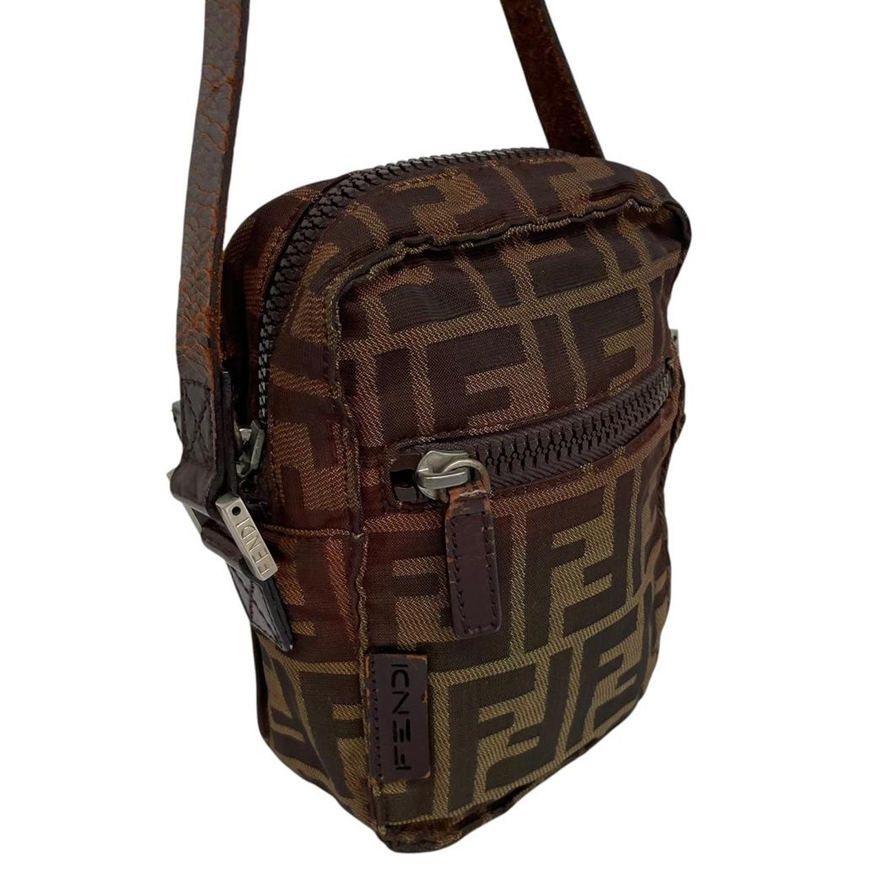 Fendi brown duffel bag with monogram canvas, visible wear and cracking on strap.