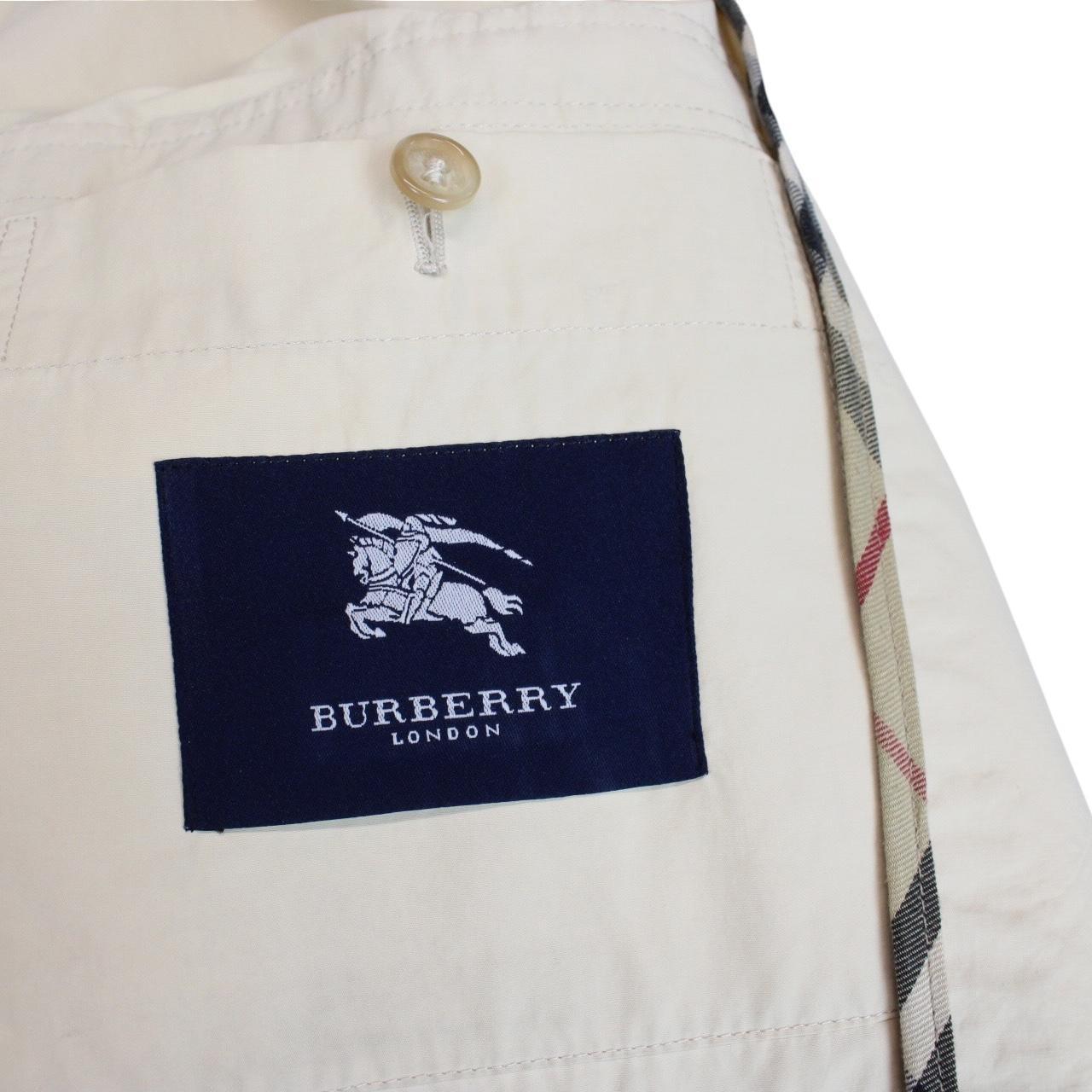 Burberry beige coat with classic check pattern and logo detail on collar.
