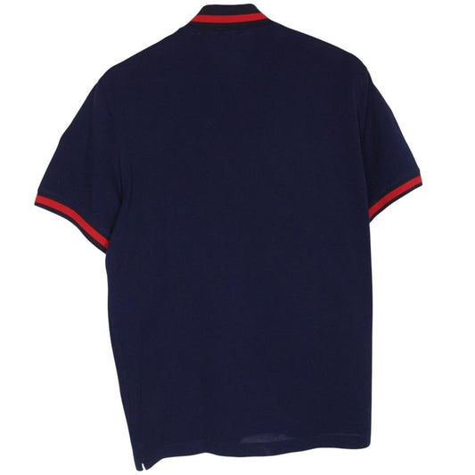 Moncler navy blue short sleeve polo shirt with embroidered logo and cotton material.