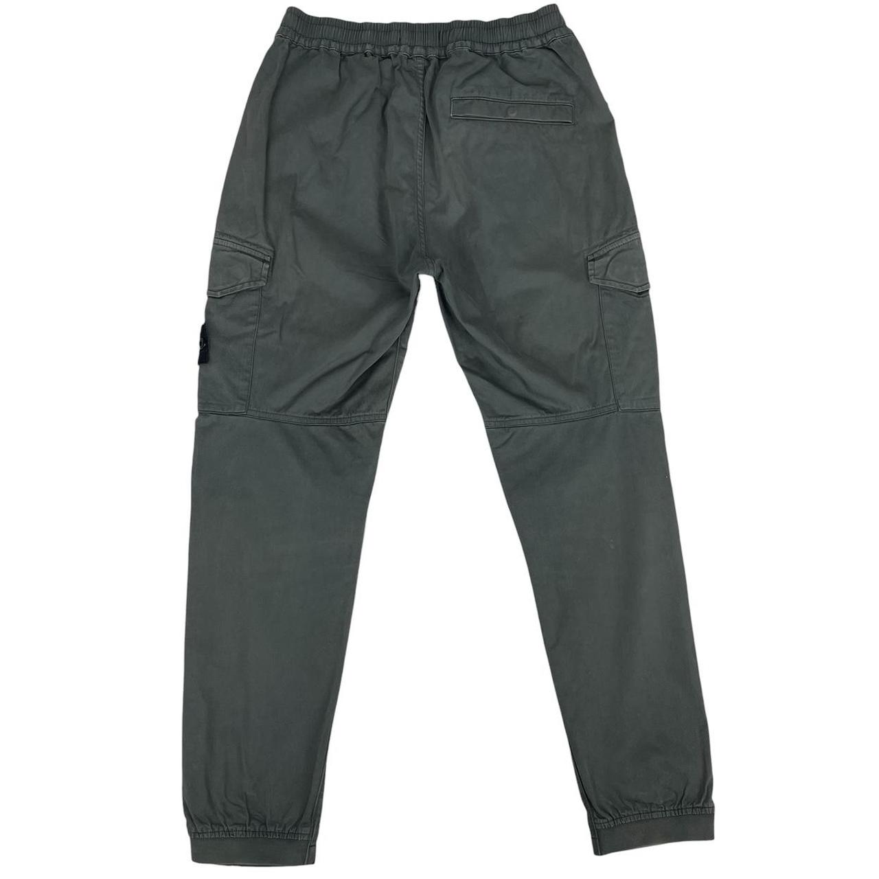 Stone Island grey cargo trousers with logo patch and pockets, visible discolouration.