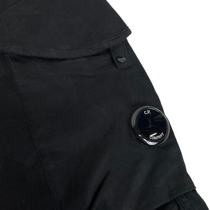 CP Company navy blue tapered fit cargo trousers with lens detail and pockets.