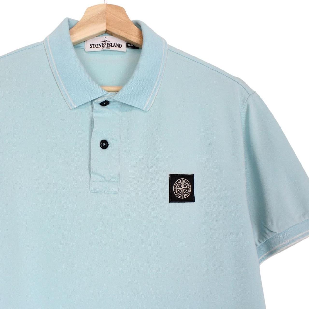 Stone Island blue polo shirt with embroidered compass logo and slim fit cotton material.