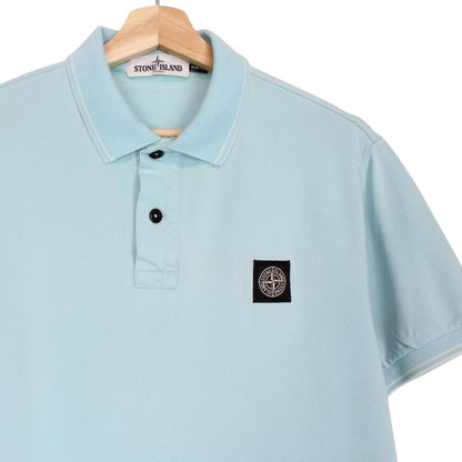 Stone Island blue polo shirt with embroidered compass logo and slim fit cotton material.
