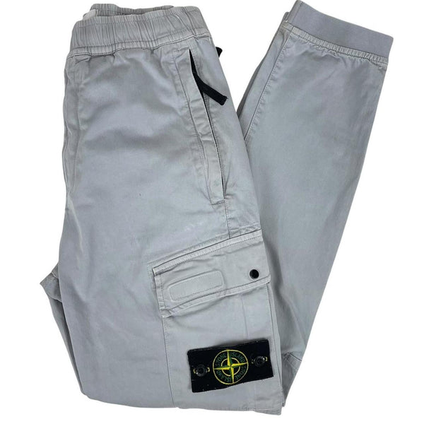 Stone Island blue cargo trousers with logo patch and RE-T fit, visible stain on left leg.
