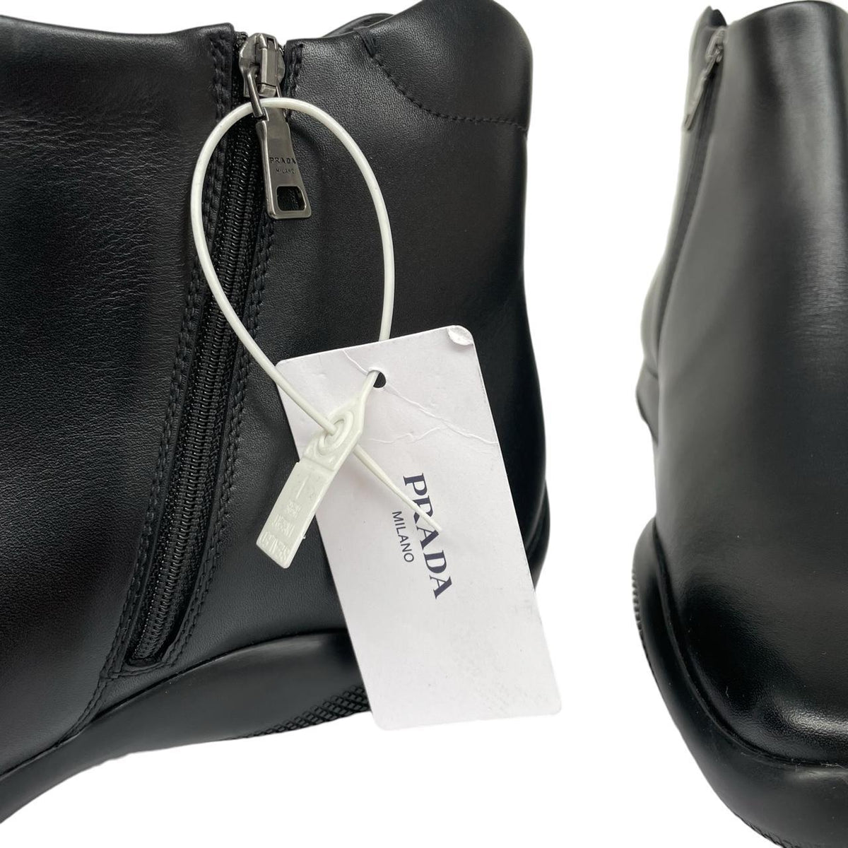 Prada black calfskin leather ankle boots with logo detail and original dust bags.