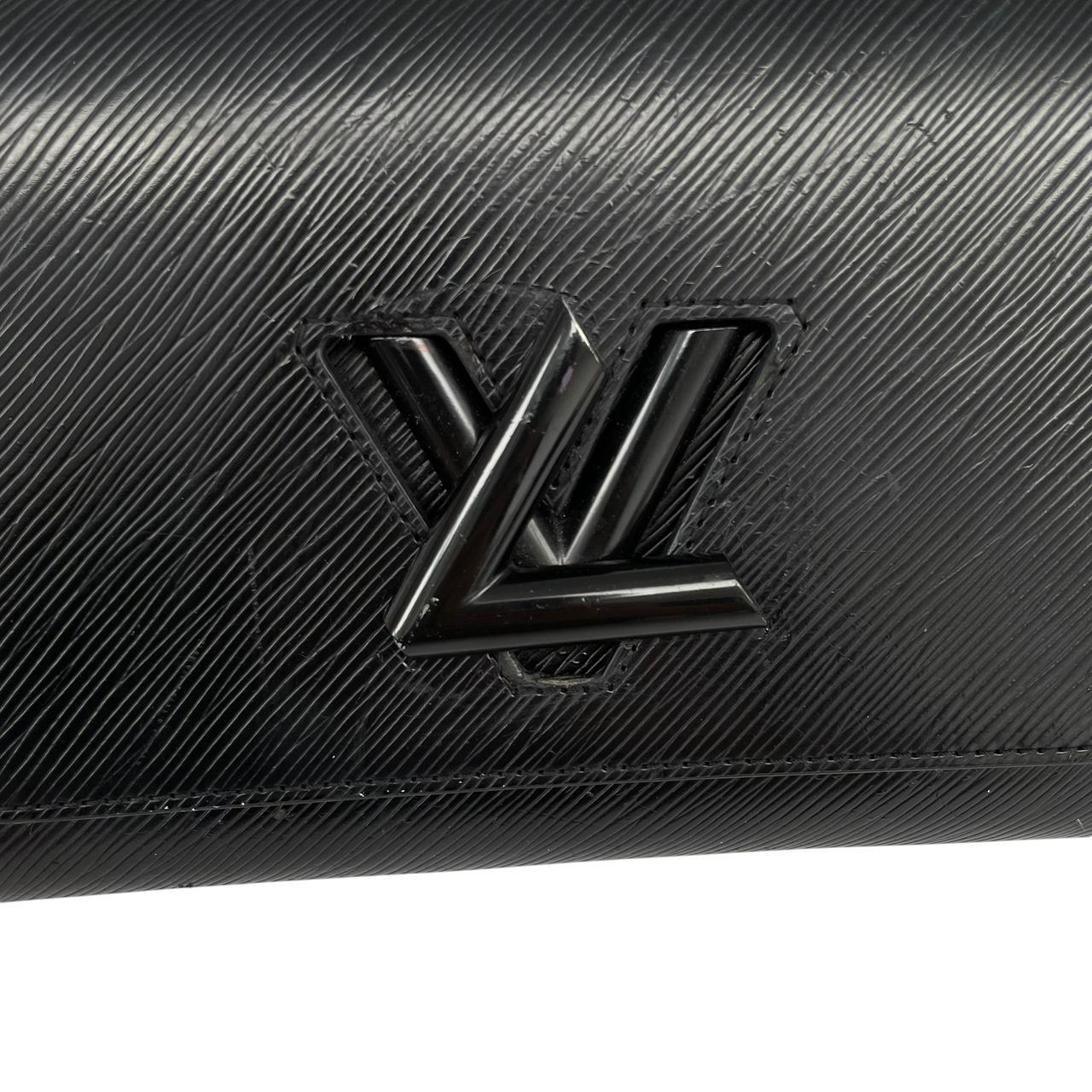Louis Vuitton black Epi leather duffel bag with twist lock and visible wear.
