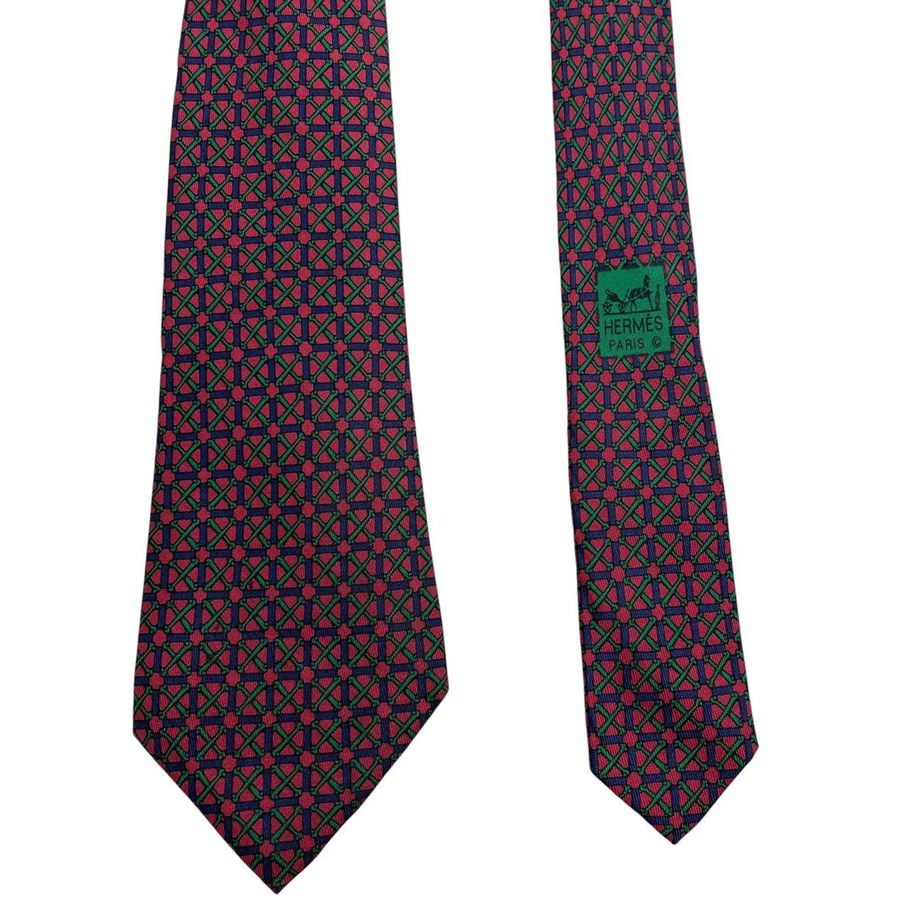 Hermes silk tie featuring geometric print in red, blue, and green colors.