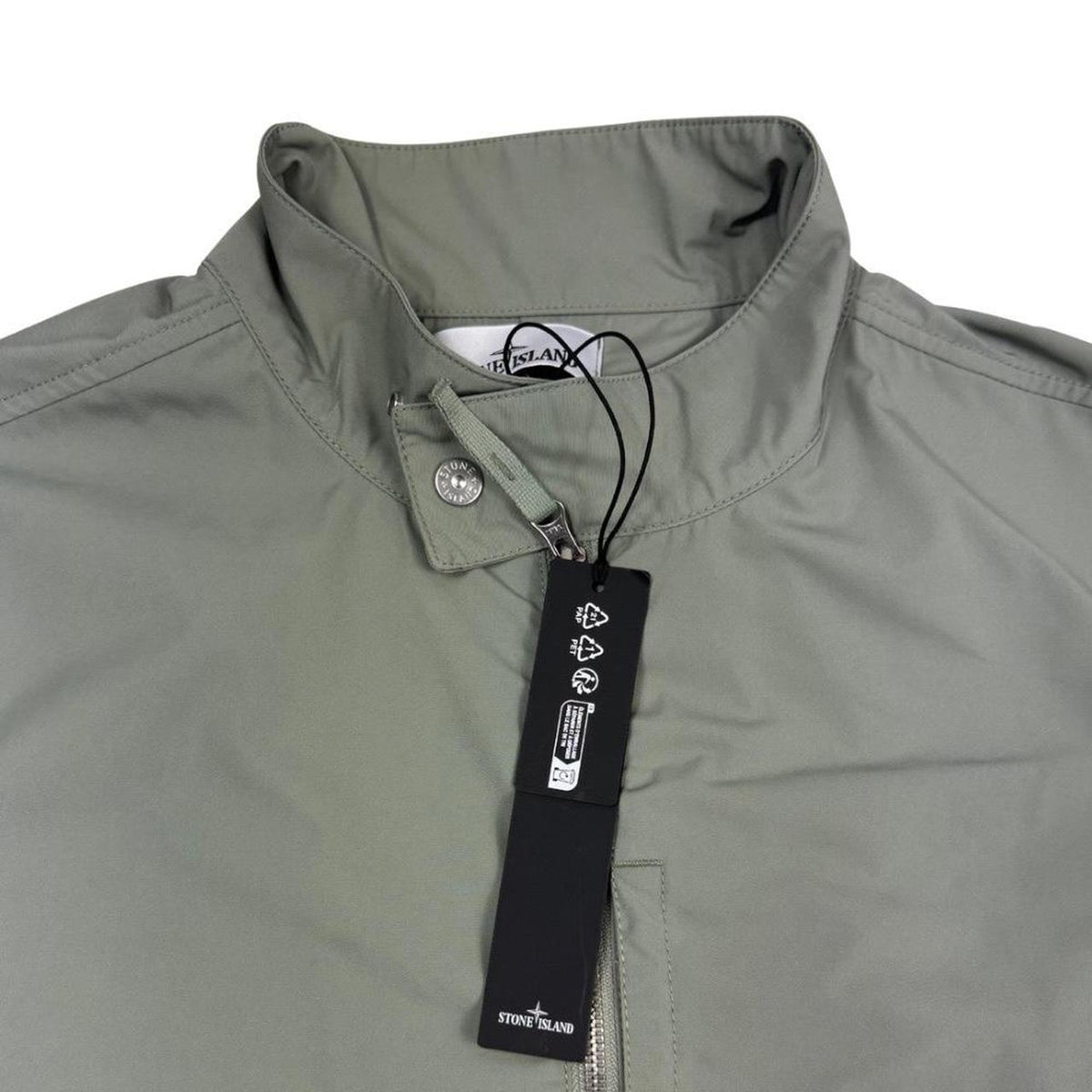 Stone Island green full zip jacket with logo patch and micro twill fabric.