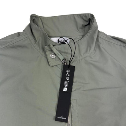 Stone Island green full zip jacket with logo patch and micro twill fabric.