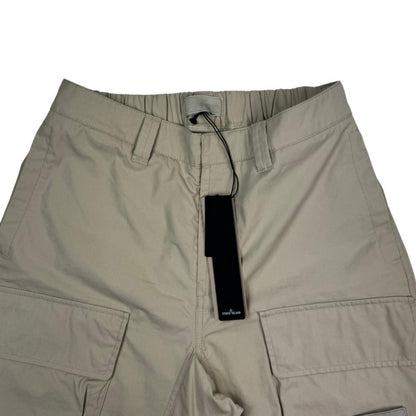 Stone Island beige cargo trousers with logo patch and multiple pockets.