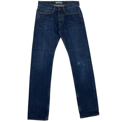 Stone Island navy blue straight jeans with logo patch and visible scuff on left knee.