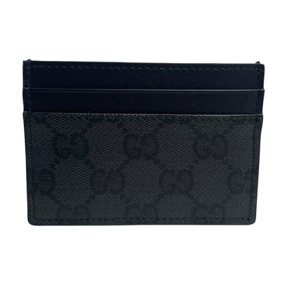 Gucci black card holder featuring Supreme GG monogram pattern in leather and canvas.