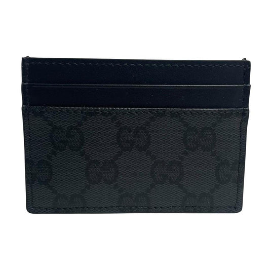 Gucci black card holder featuring Supreme GG monogram pattern in leather and canvas.