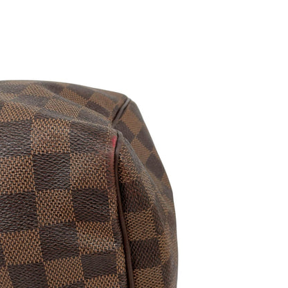 Louis Vuitton brown Damier Ebene canvas Speedy 35 bag with logo and gold-tone hardware.