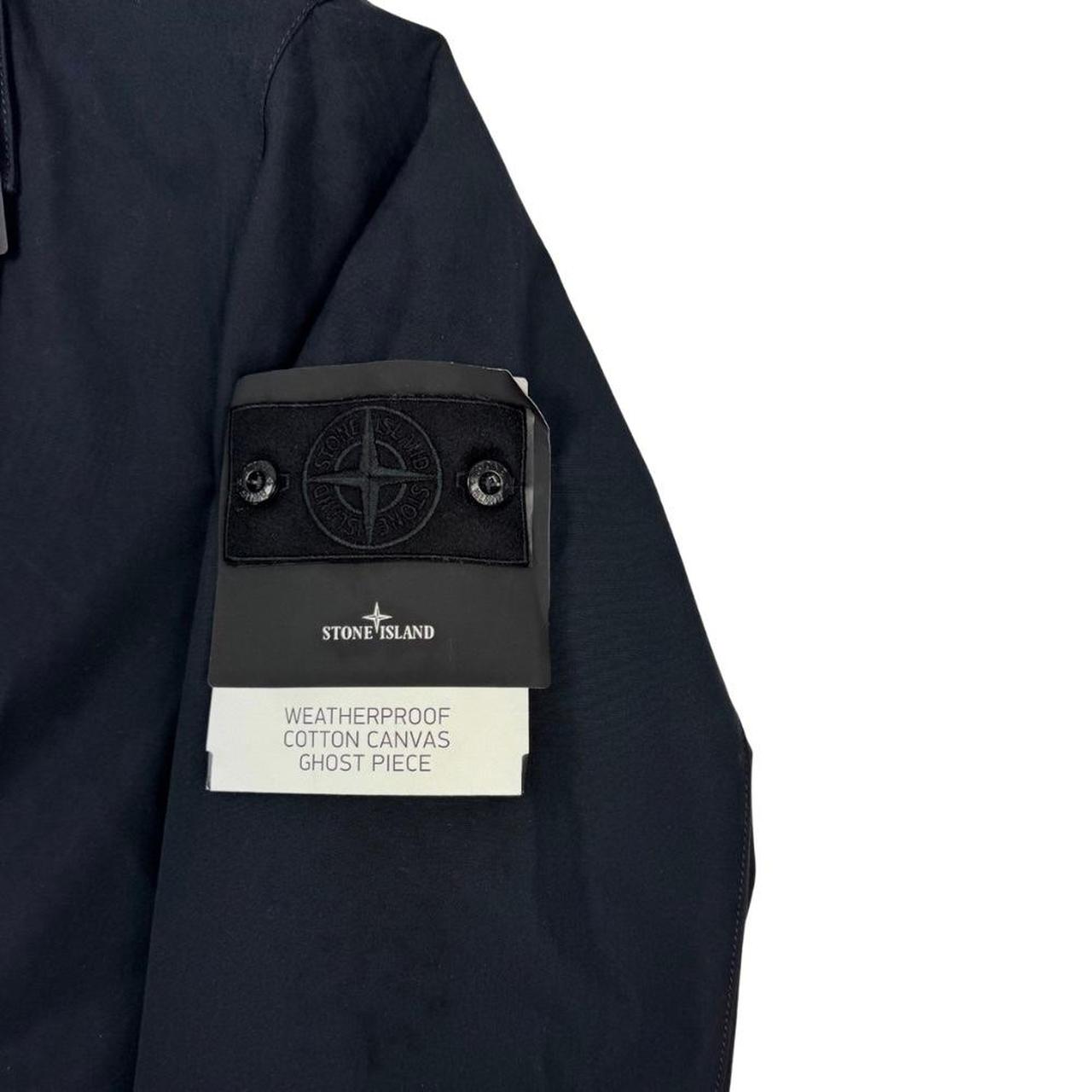 Stone Island navy blue jacket weatherproof cotton canvas with ghost logo detail.