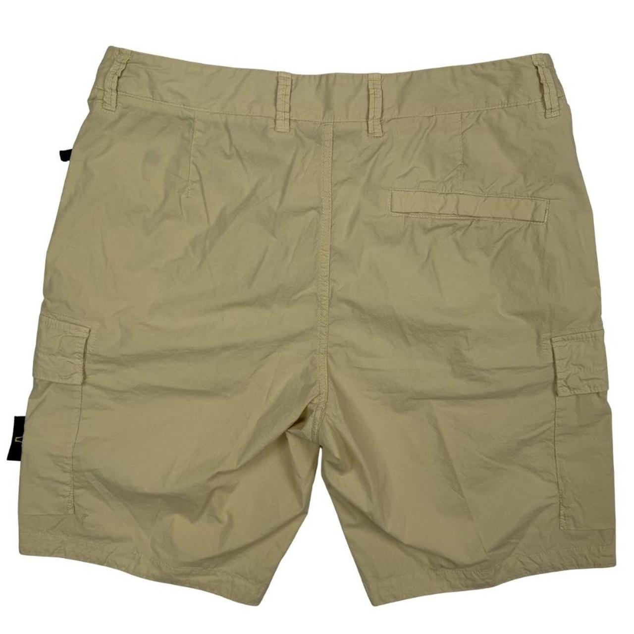 Stone Island beige cargo shorts with logo patch and multiple pockets in cotton material.