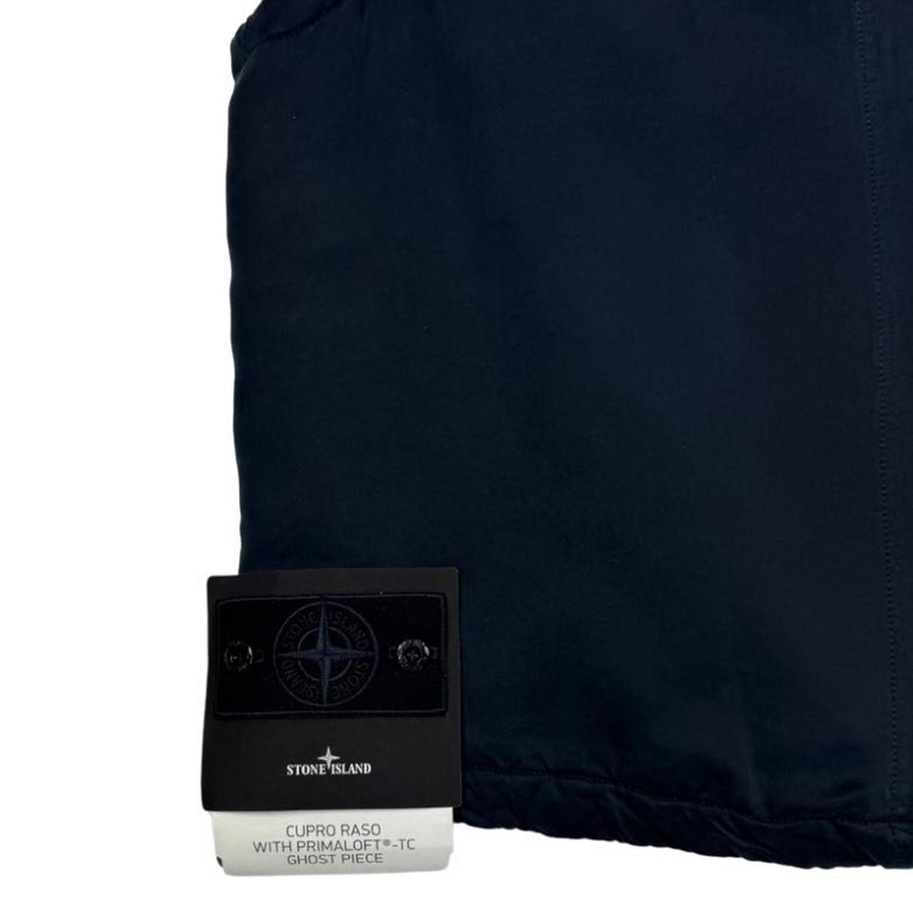 Stone Island navy blue vest jacket with logo patch and Primaloft material.