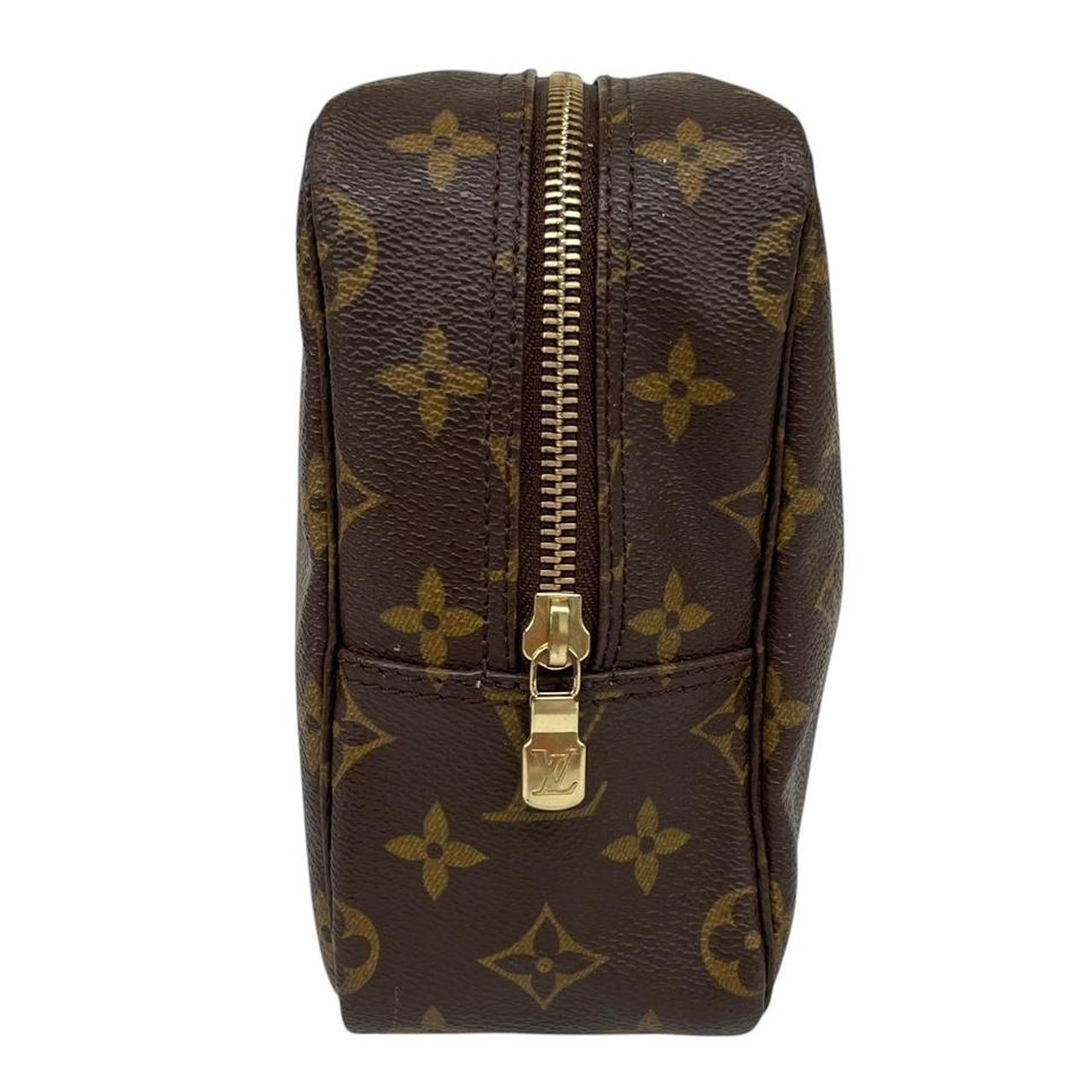 Louis Vuitton brown and tan monogram toiletry pouch with iconic logo and canvas material.