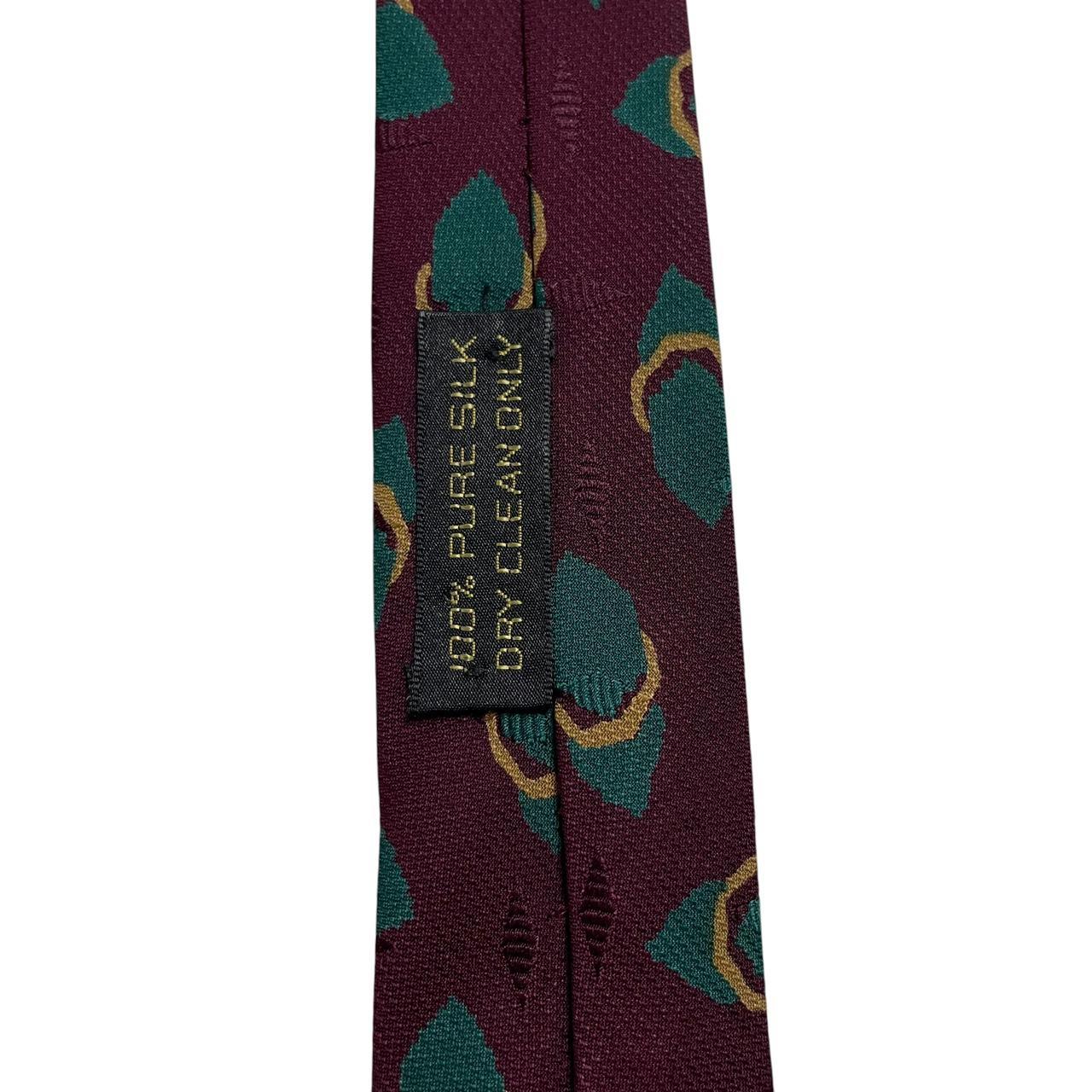 Giorgio Armani burgundy silk tie with geometric print and logo detail.