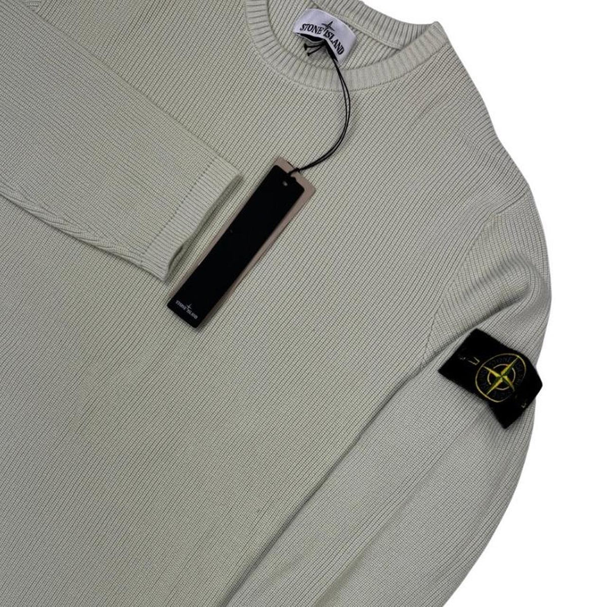 Stone Island beige waffle knit jumper with logo patch and organic cotton material.