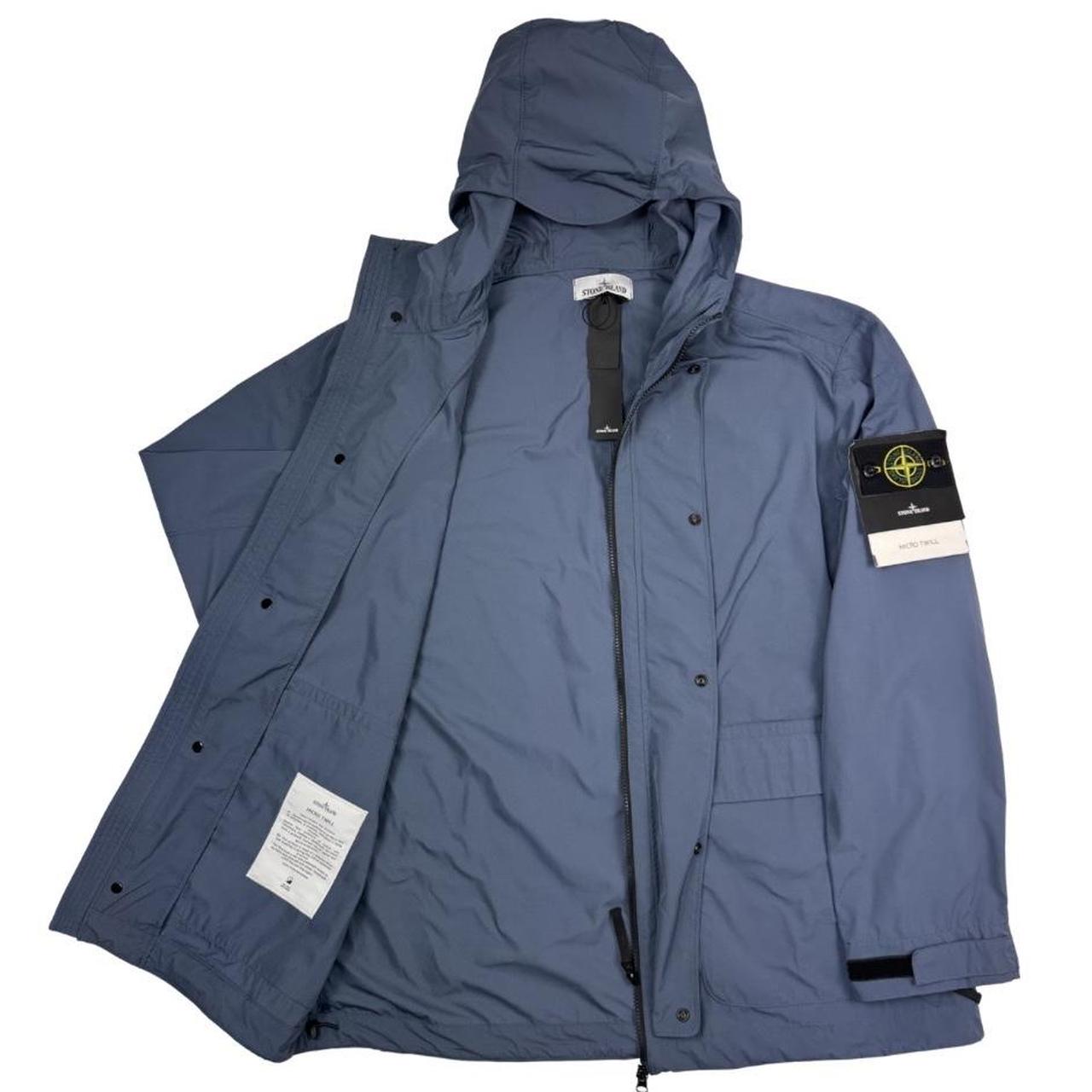 Stone Island blue hooded jacket with logo patch and micro twill fabric.