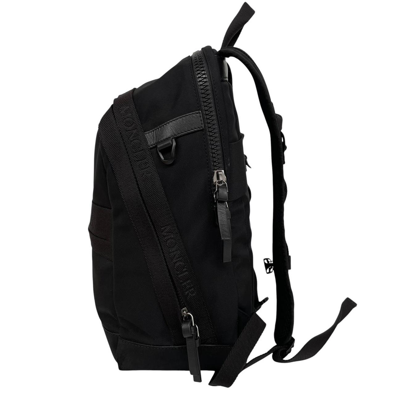 Moncler black duffel bag with logo patch and durable material, pre-loved condition.