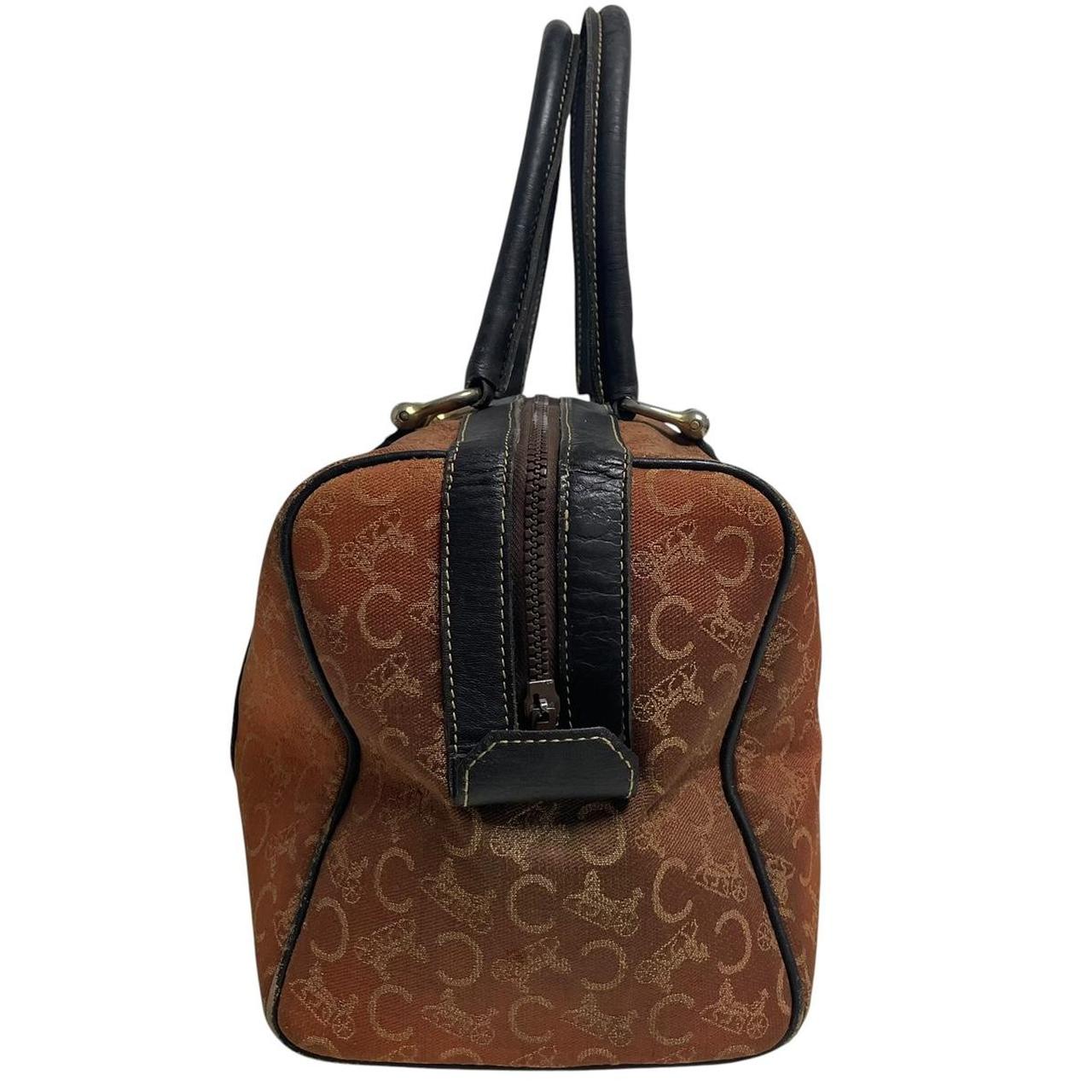 CELINE orange duffel bag with Macadam canvas and leather, visible wear and discolouration.