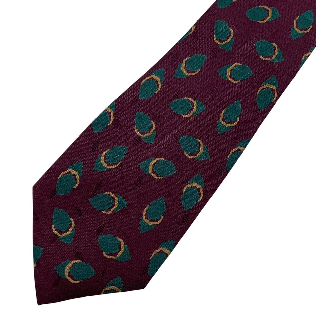 Giorgio Armani burgundy silk tie with geometric print and logo detail.