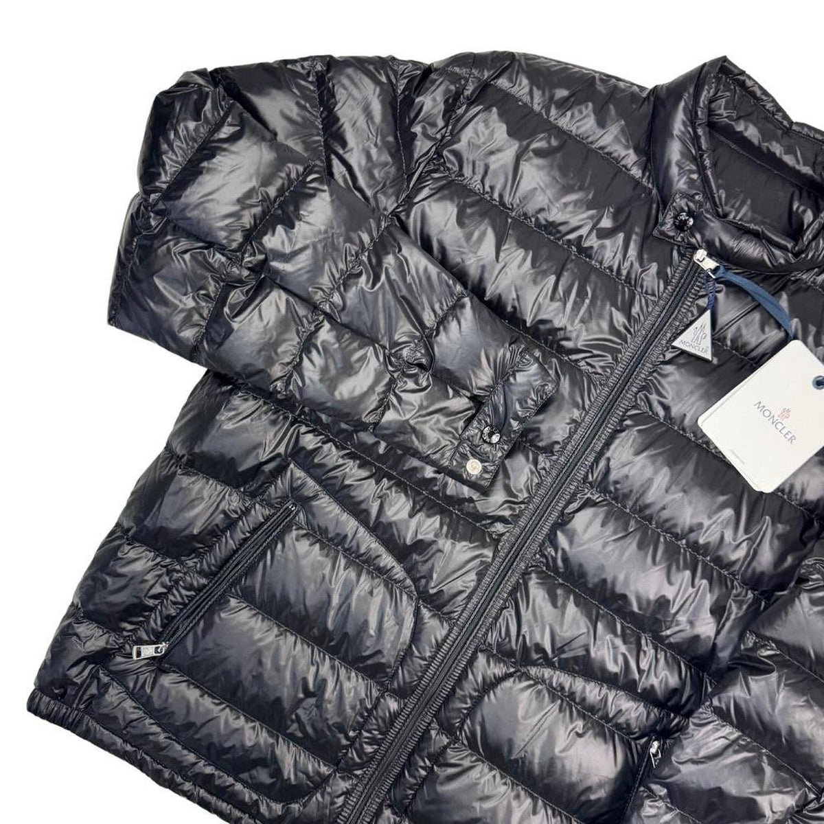 Moncler black nylon down jacket with full zip and logo patch on sleeve.