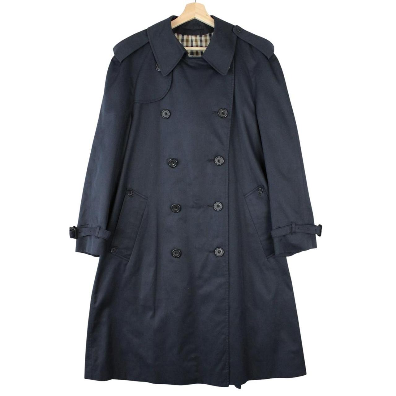 Aquascutum navy blue double breasted trench coat with house check pattern and logo.