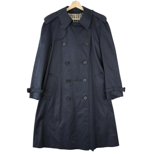 Aquascutum navy blue double breasted trench coat with house check pattern and logo.