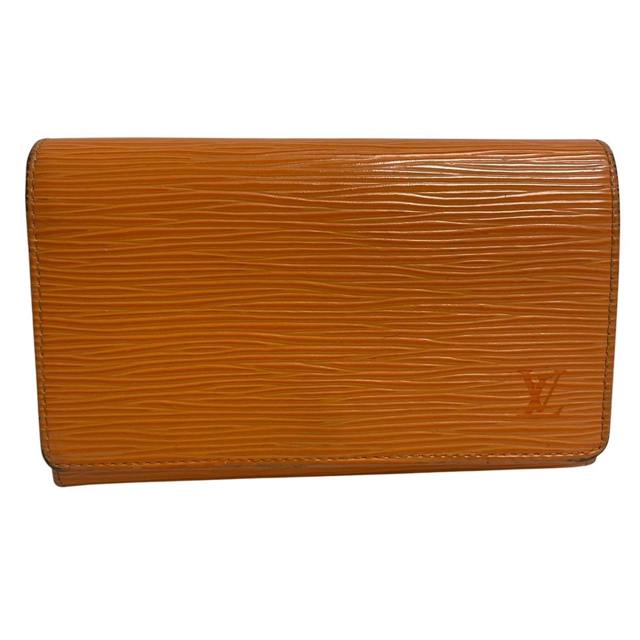 Louis Vuitton orange leather wallet with Epi texture and embossed logo detail.