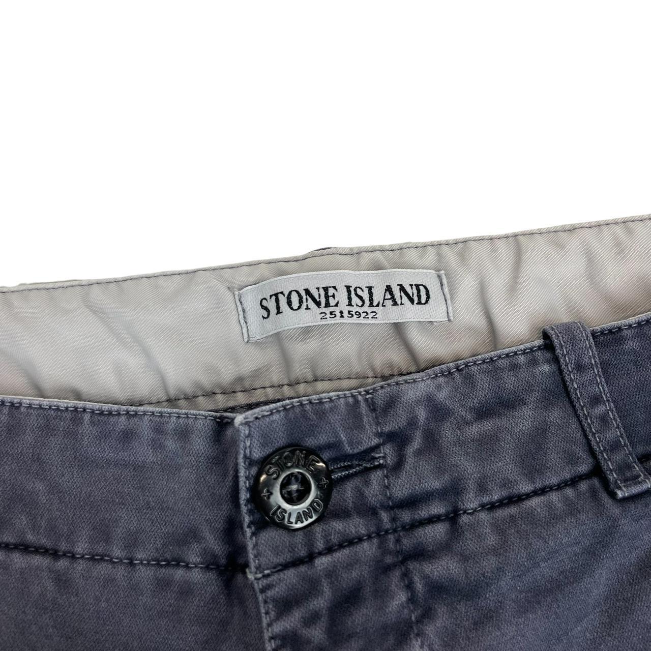 Stone Island navy blue slim fit cotton trousers with logo patch and fading details.