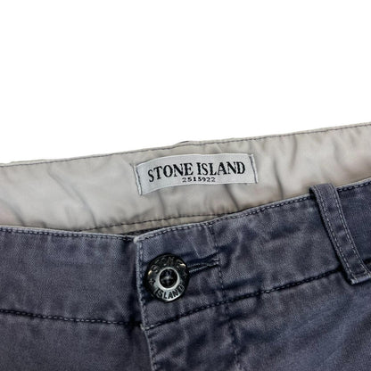 Stone Island navy blue slim fit cotton trousers with logo patch and fading details.