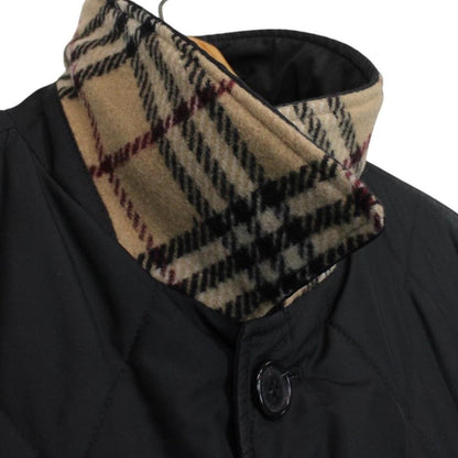 Burberry black coat with Nova Check lining and diamond quilted pattern.