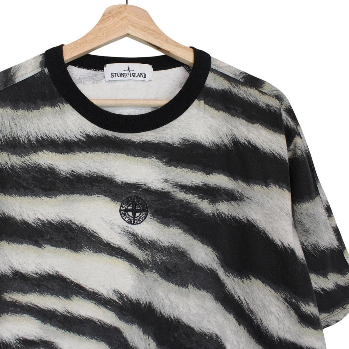 Stone Island short sleeve t-shirt in tiger camo pattern with logo patch on sleeve.