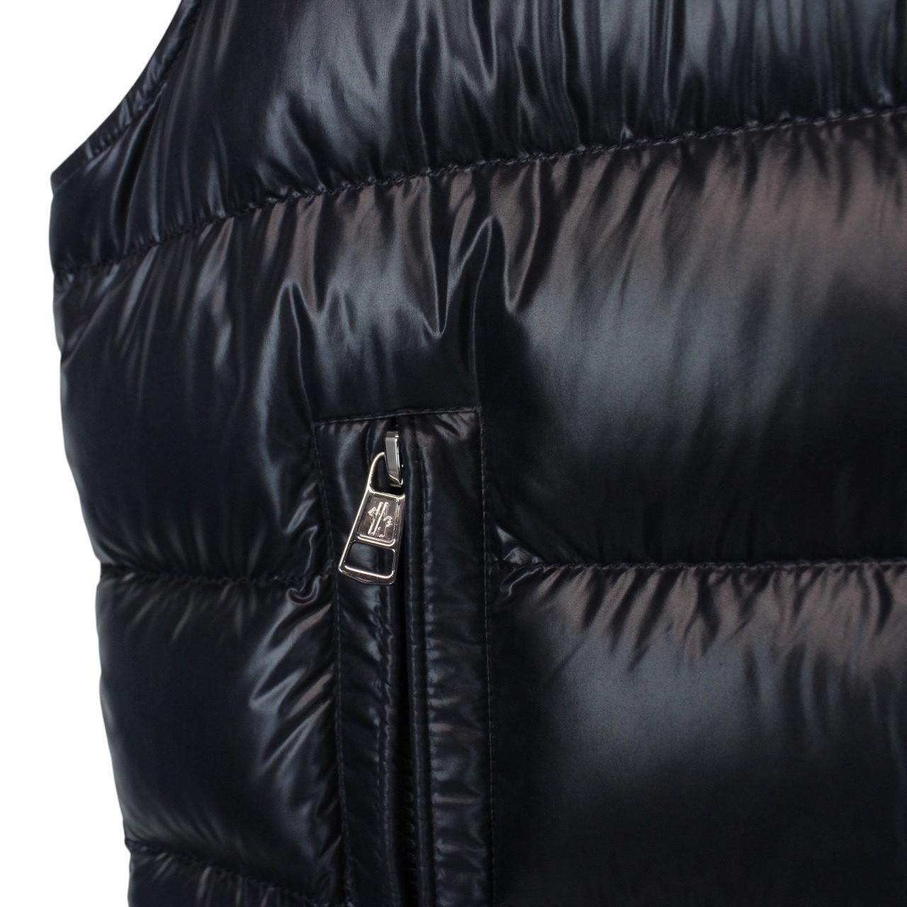 Moncler navy blue hooded nylon down gilet with logo and quilted texture.