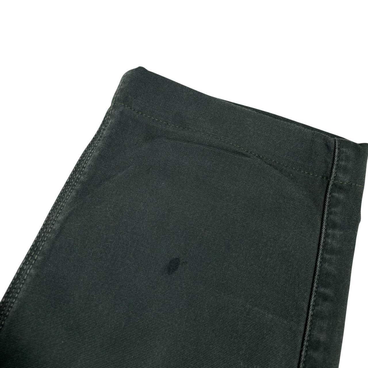 Stone Island green slim fit cotton trousers with logo patch and faded details.