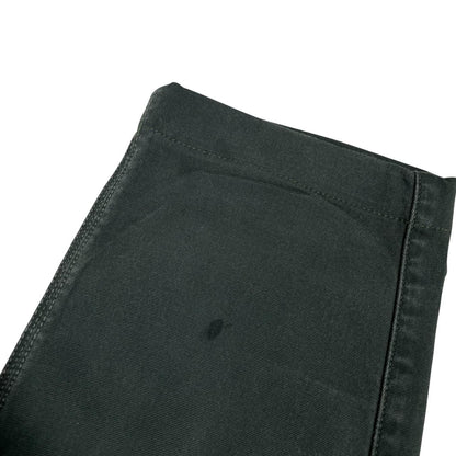 Stone Island green slim fit cotton trousers with logo patch and faded details.