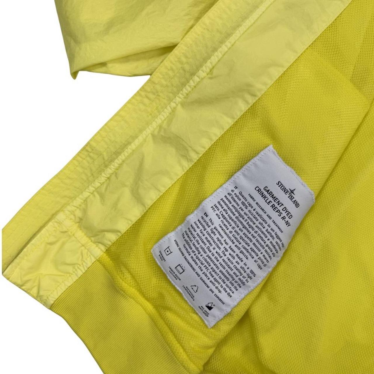 Stone Island yellow full zip jacket with crinkle texture and iconic compass logo.