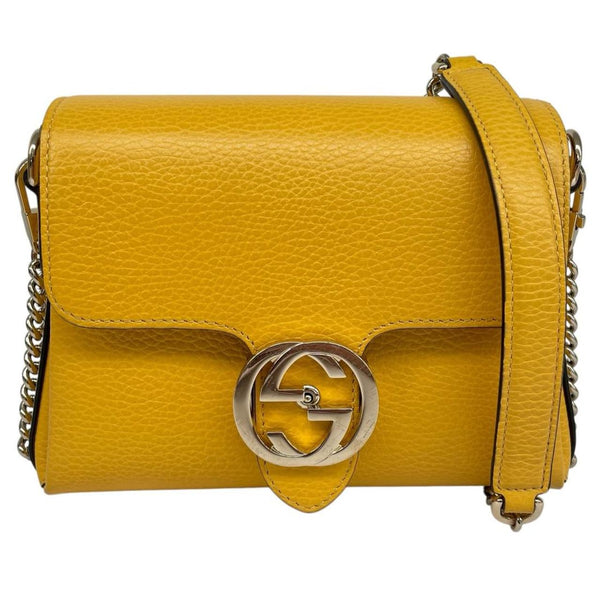 Gucci yellow leather crossbody bag with interlocking G logo and minor metal scratches.