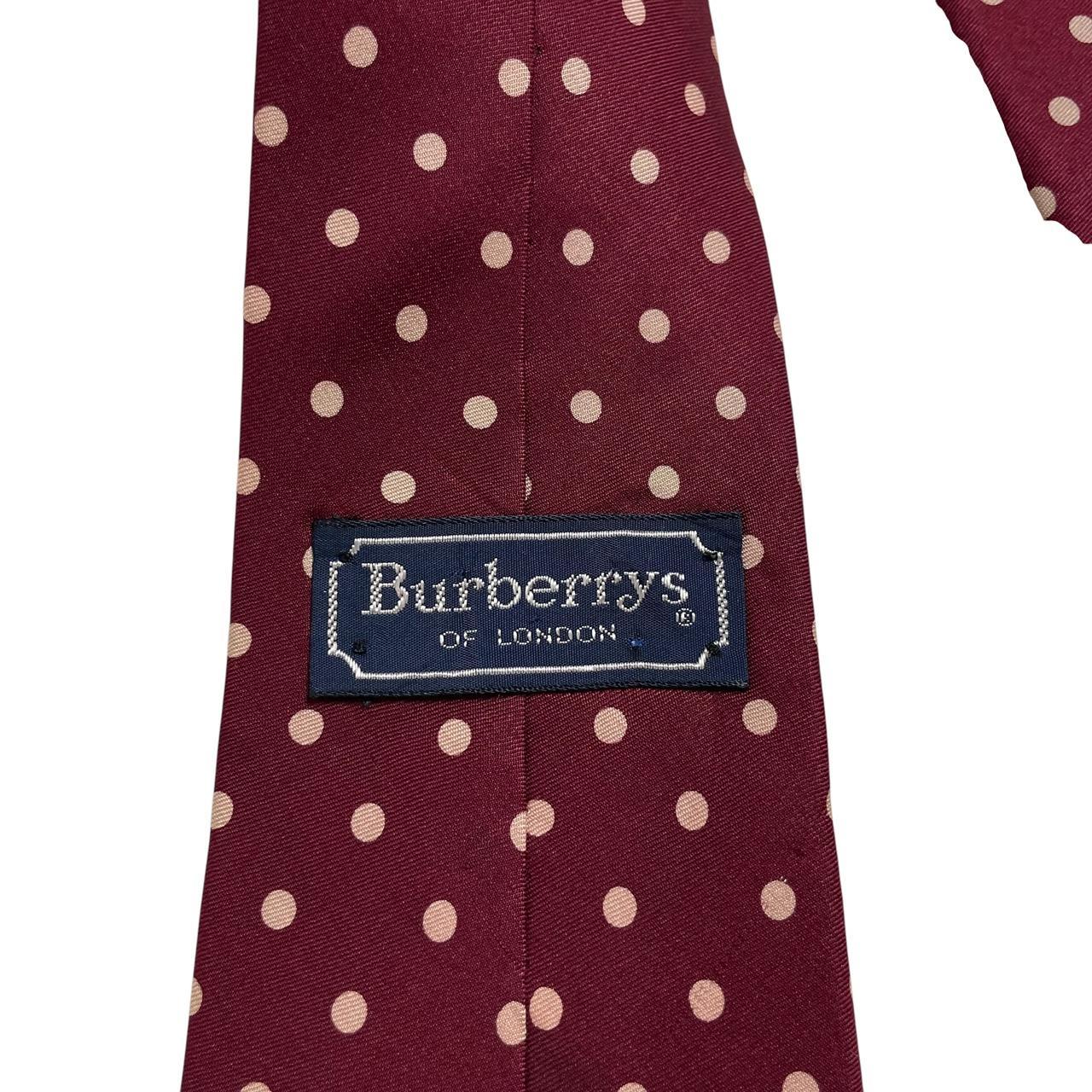Burberry burgundy silk tie with white polka dots and classic logo detail.