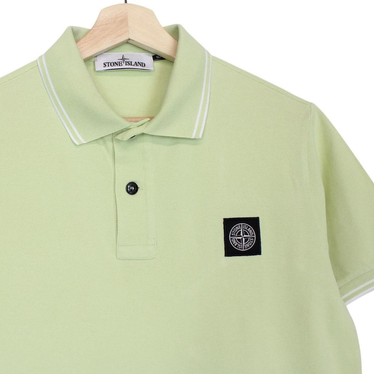 Stone Island green polo shirt with compass logo, cotton material, short sleeves.