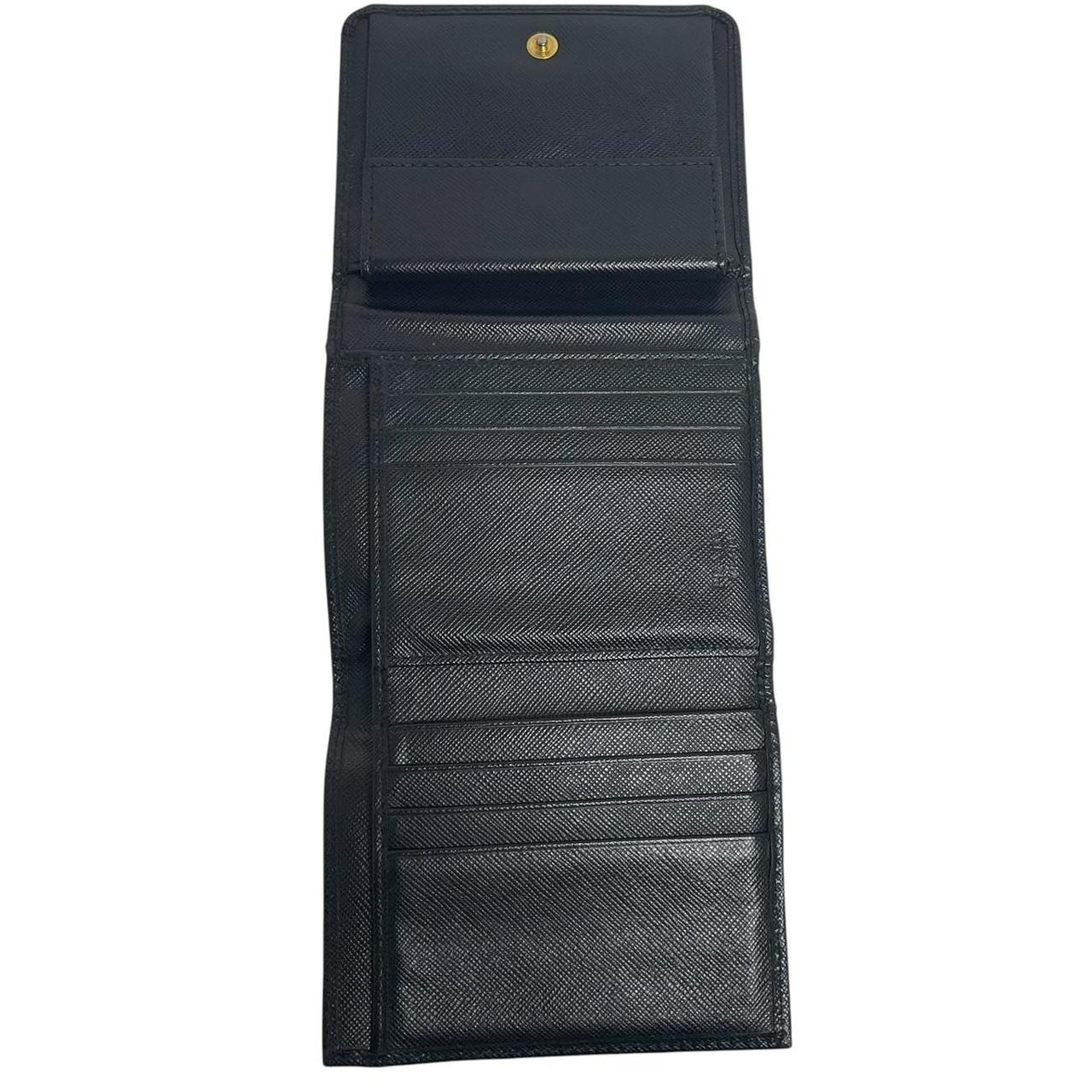 Prada black bifold wallet Saffiano leather with logo embossed detail.