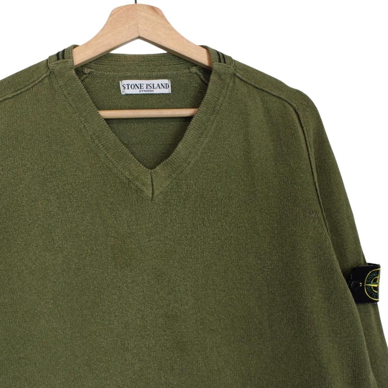 Stone Island green v-neck cotton knit jumper with logo patch and visible wear.