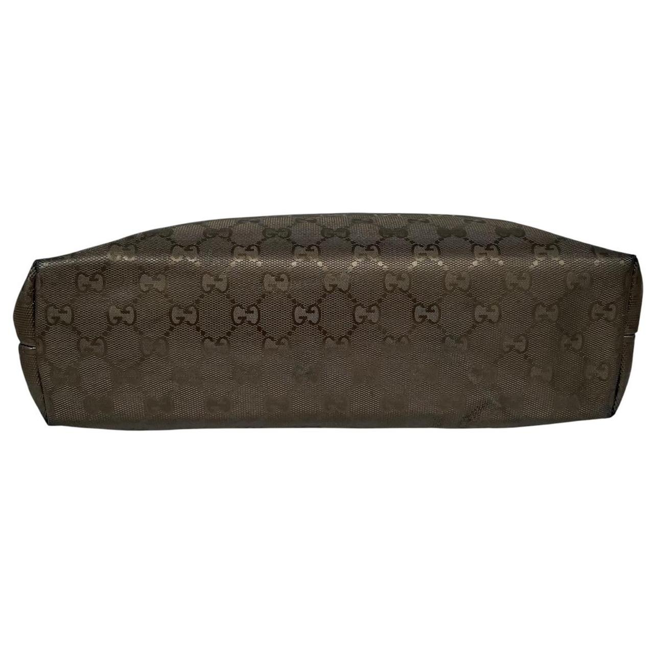 Gucci khaki green duffel bag with metallic monogram canvas and leather trim details.